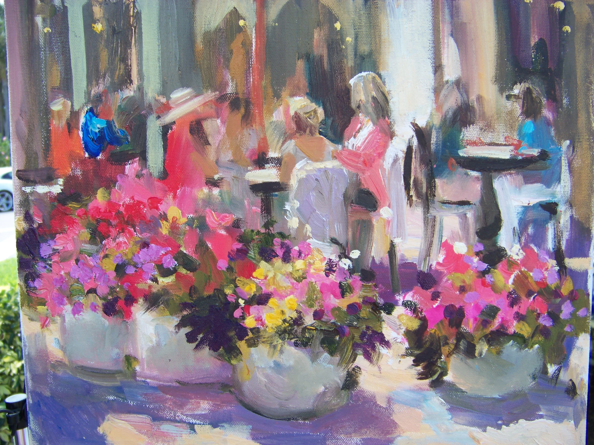 Flowers on a table beside an open window
